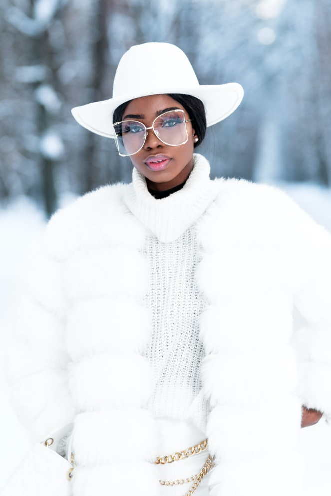 A woman wearing white clothes in the snow