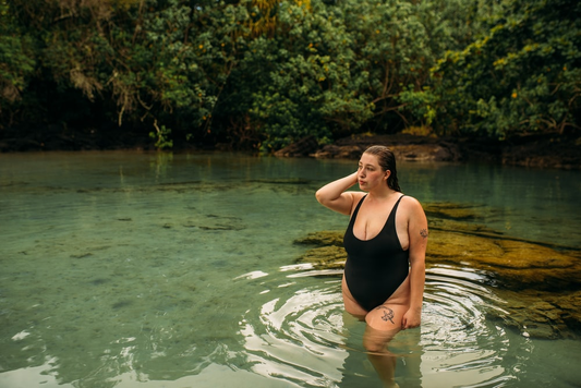 A woman in a black swimsuit in a lake