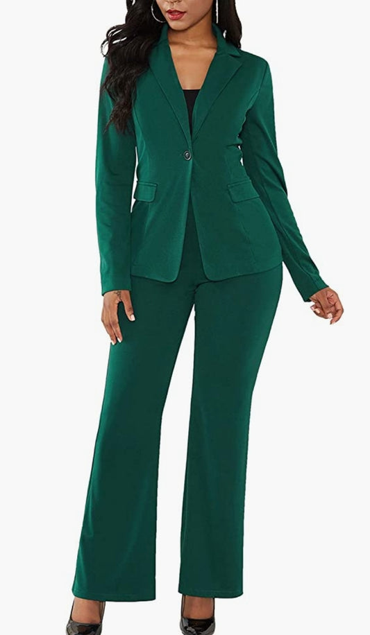 Women standing in hunter green  two piece pants suit.  Jacket buttons with one button and black shirt underneath.  Pants are pull on but has one button as accent and are classic fit.  Woman paired the suit with black heals. 